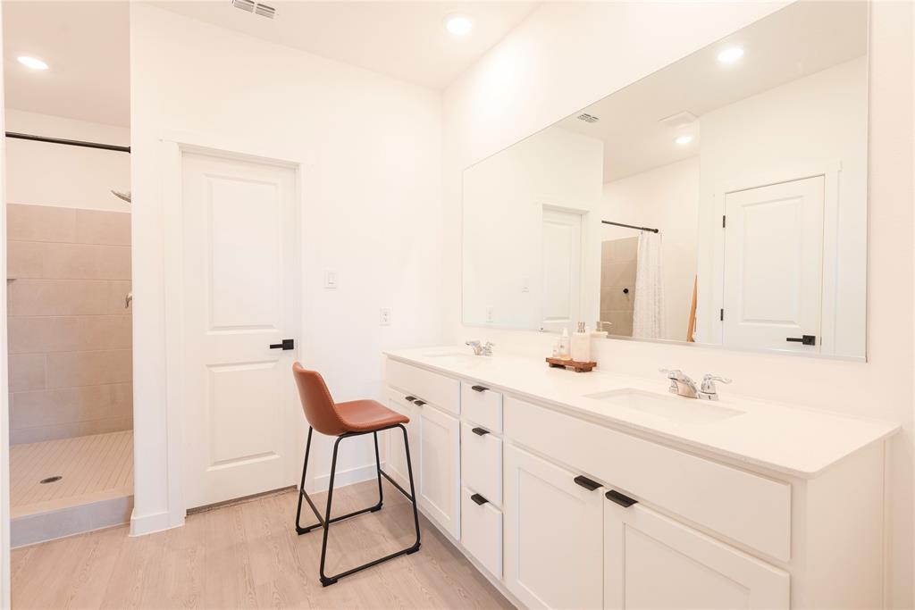 512 Capstone Court Princeton, TX 75407 - Photo 29 of 32 a bathroom with a sink vanity and a mirror