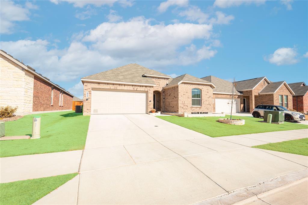 512 Capstone Court Princeton, TX 75407 - Photo 5 of 32 a front view of a house with a yard and garage