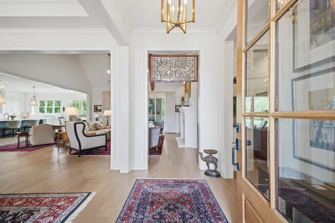 a living room with furniture fireplace and a chandelier