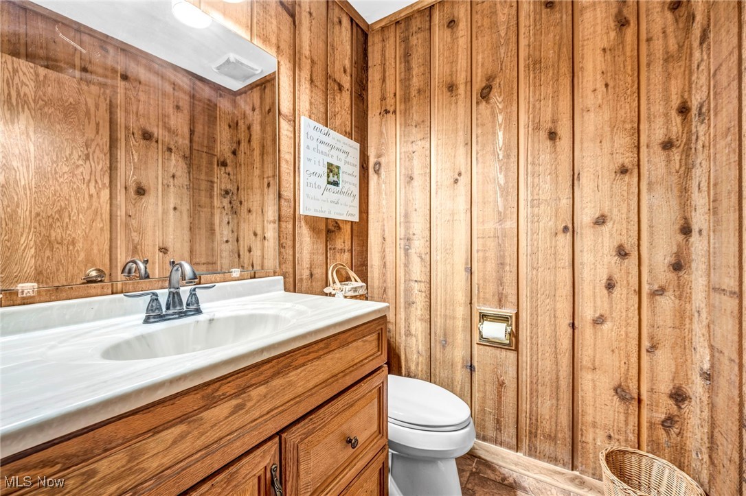 12938 Carter Road Painesville, OH 44077 - Photo 23 of 50 Bathroom with vanity and wooden walls