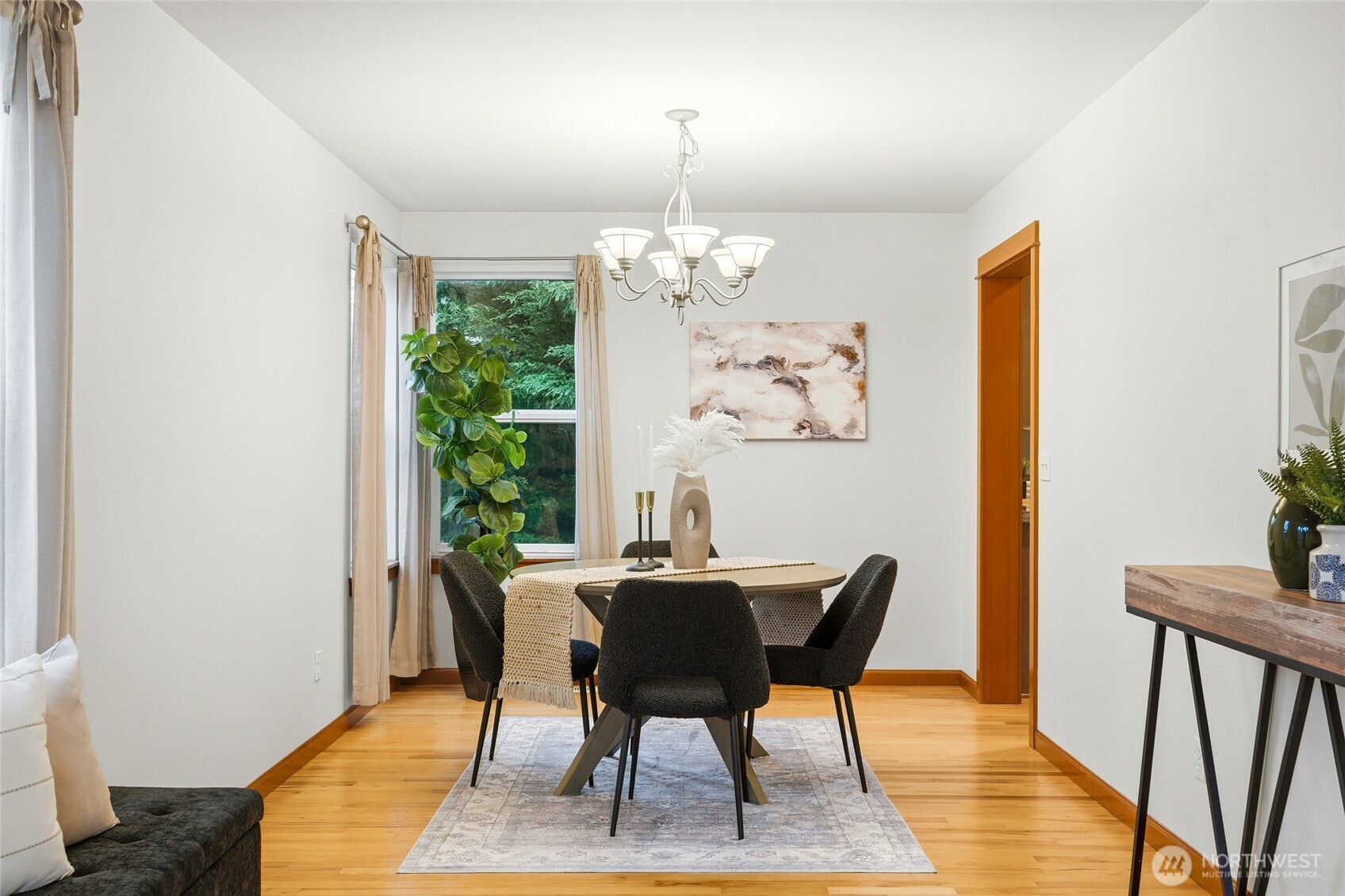 8017 64th Street Southeast Snohomish, WA 98290 - Photo 6 of 39 a dining room with furniture a rug and a chandelier