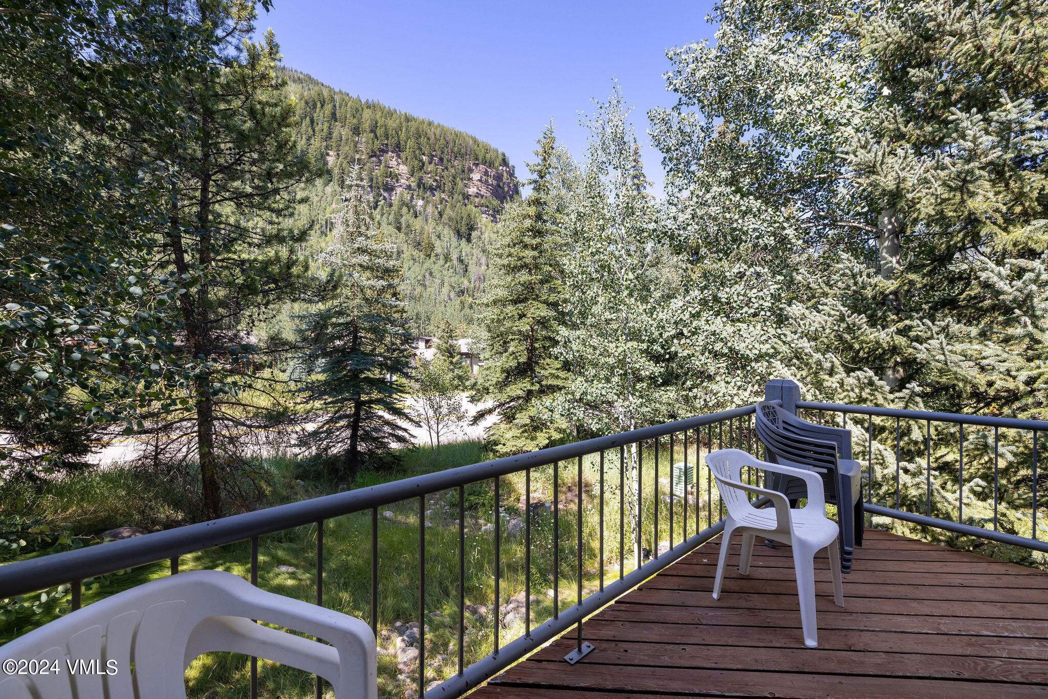 3891 Big Horn Road, Unit D Vail, CO 81657 - Photo 14 of 28 a balcony with wooden floor and trees