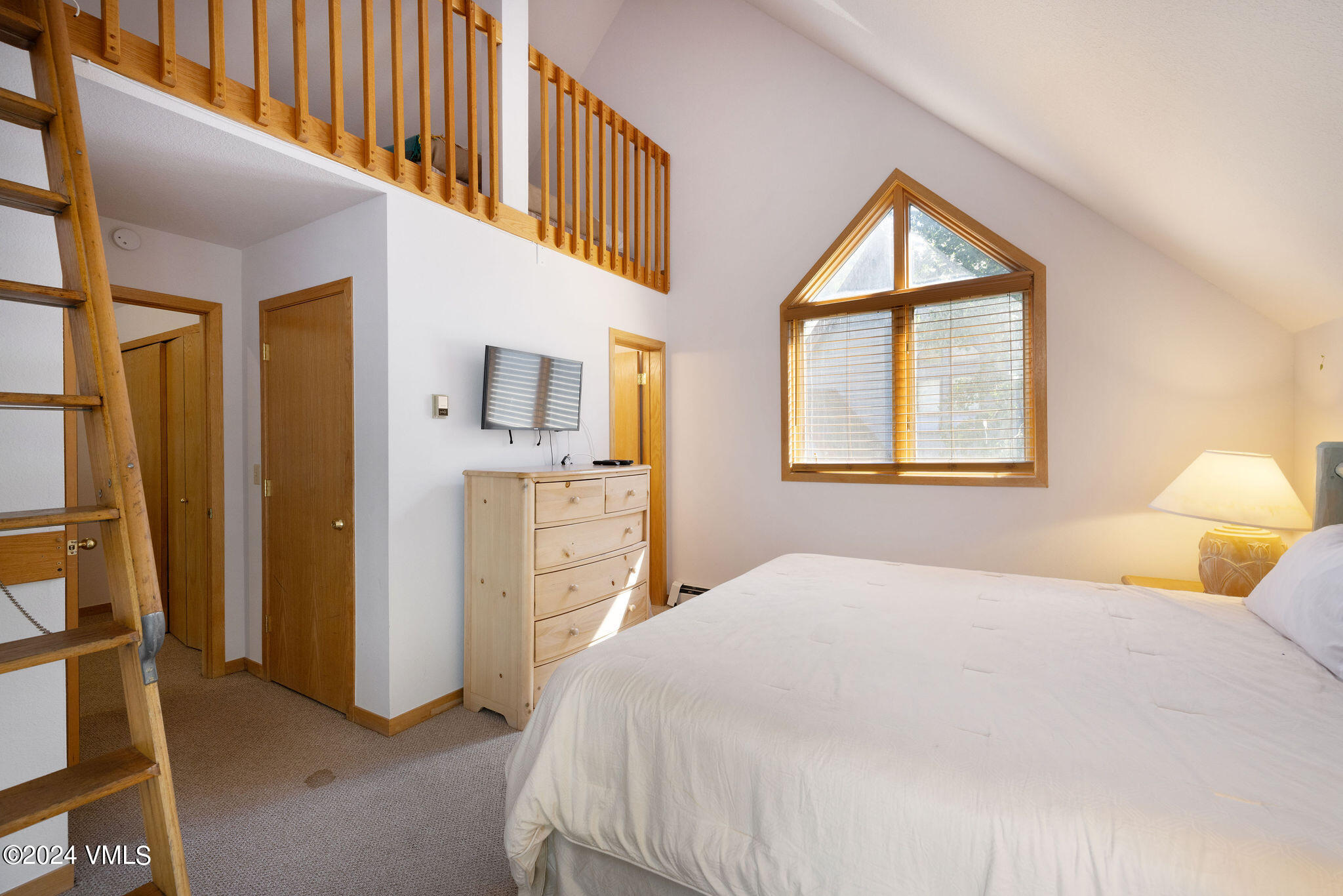 3891 Big Horn Road, Unit D Vail, CO 81657 - Photo 18 of 28 a bedroom with a bed next to a window