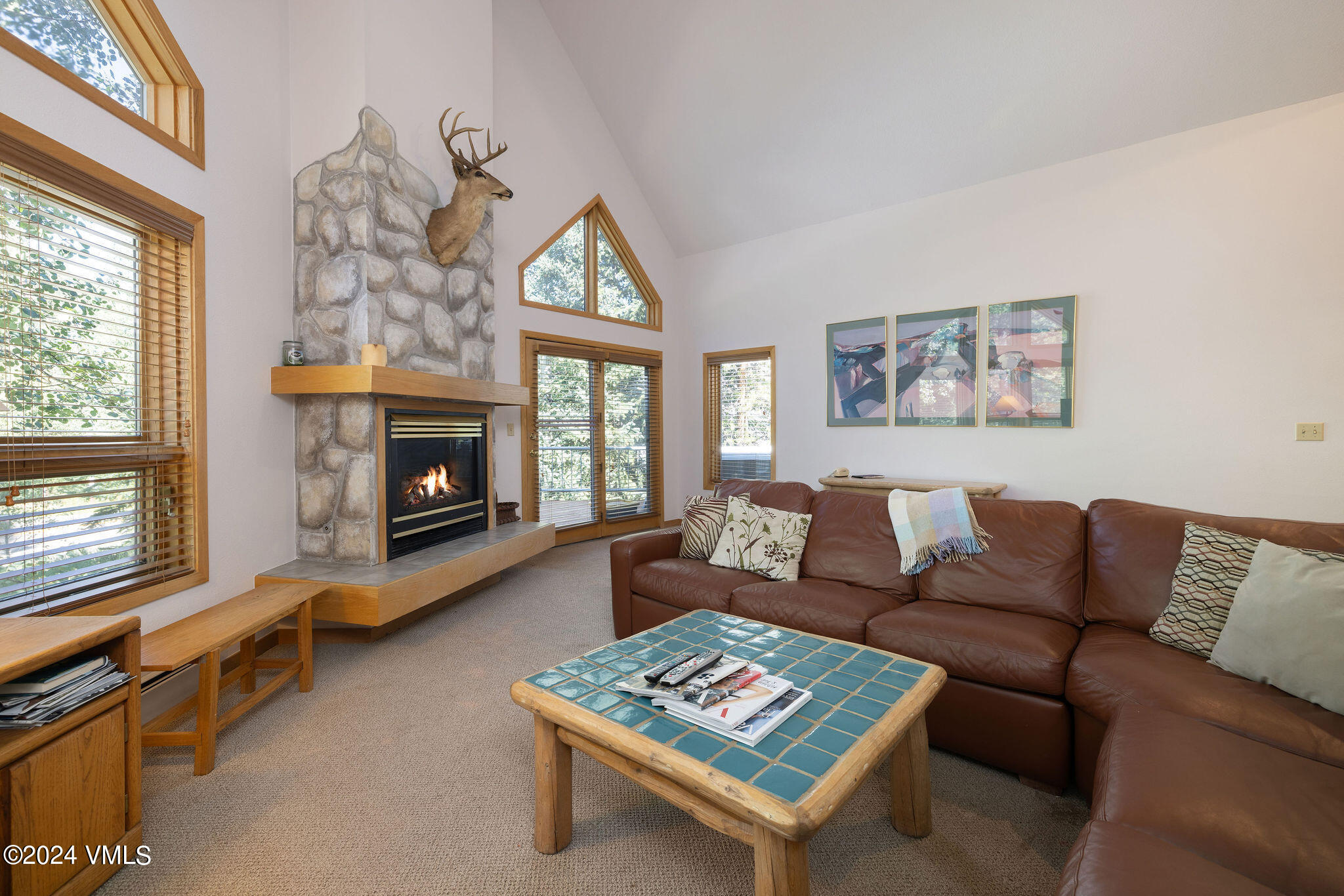 3891 Big Horn Road, Unit D Vail, CO 81657 - Photo 22 of 28 a living room with furniture a window and a fireplace