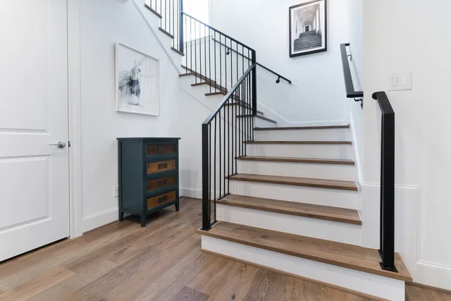 a view of entryway and hall with wooden floor