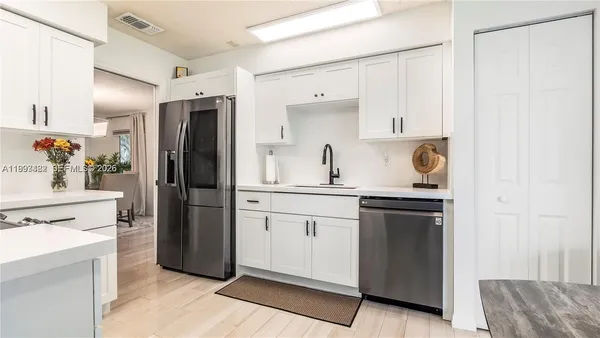 a kitchen with a sink stove and refrigerator