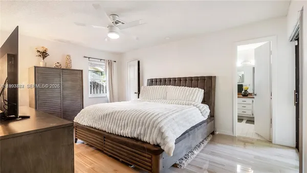 a bedroom with a bed and a flat screen tv