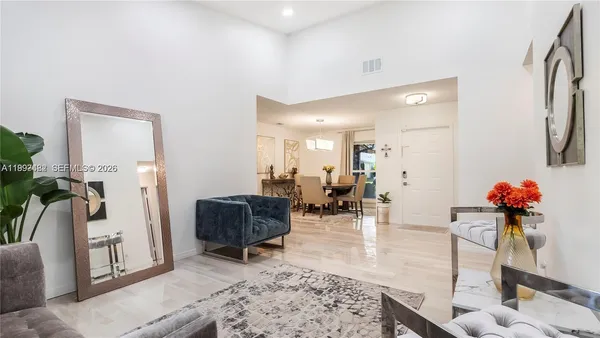 a living room with furniture and flowers