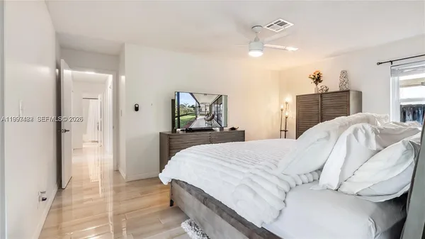 a bedroom with a bed and a chandelier