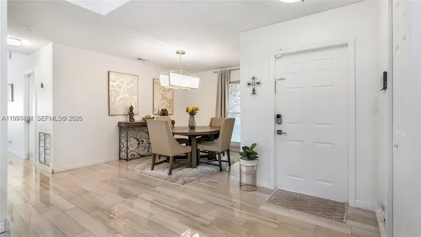 a view of a room with furniture and wooden floor