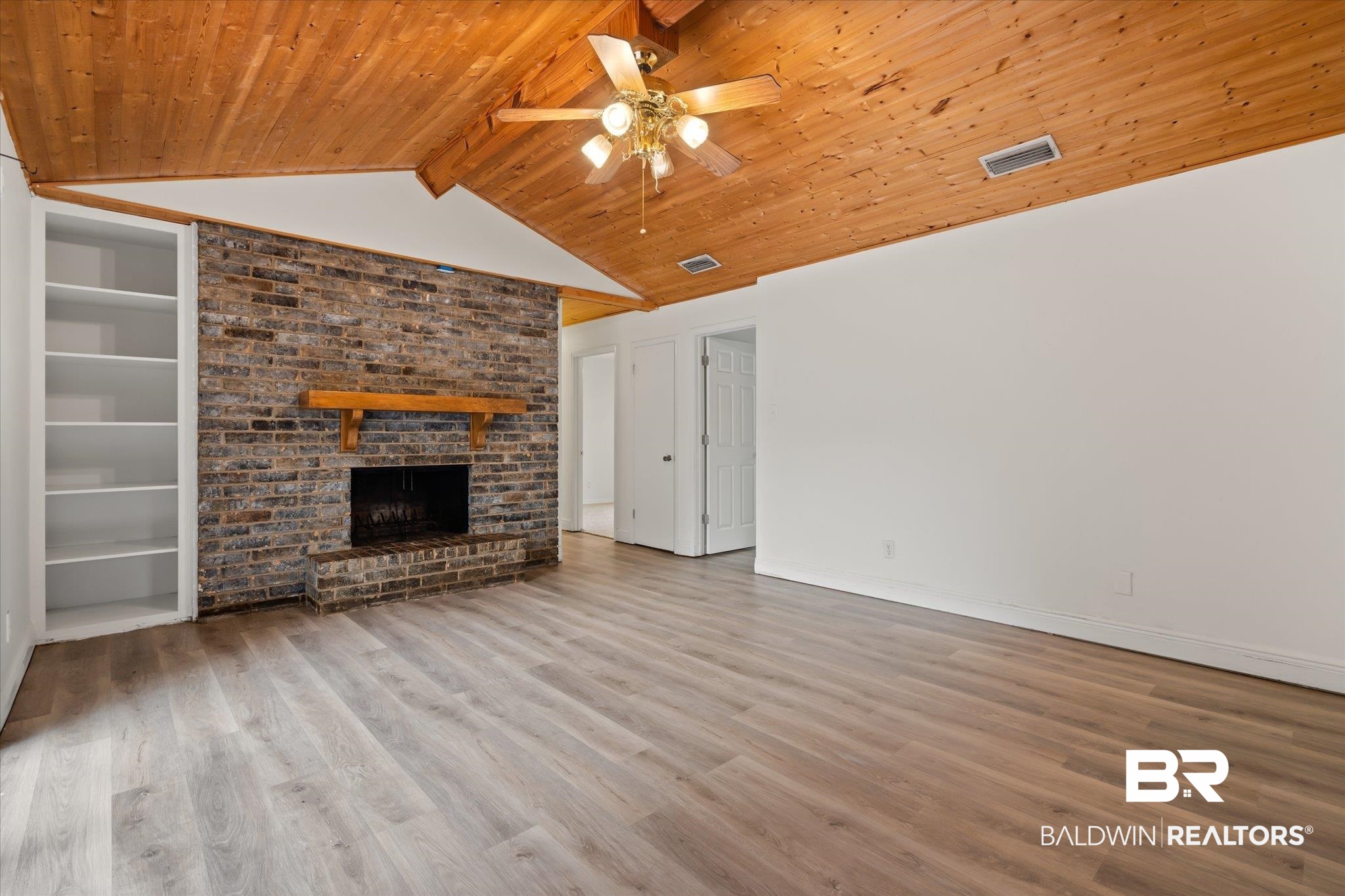 9445 Howells Ferry Road Semmes, AL 36575 - Photo 9 of 20 Unfurnished living room with light wood-type flooring, vaulted ceiling with beams, and wood ceiling