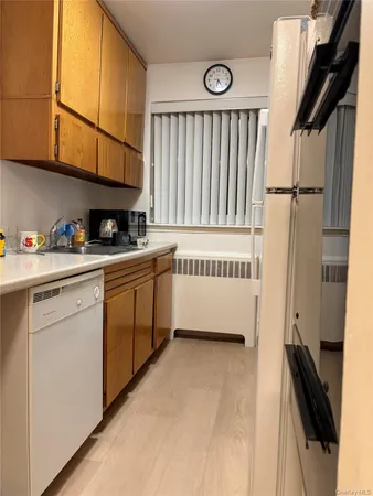 a kitchen with a cabinets and white appliances