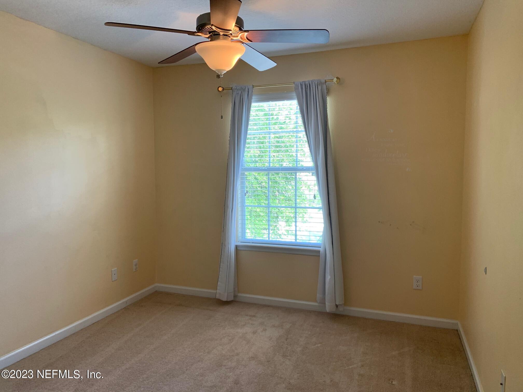 3863 Chasing Falls Road Orange Park, FL 32065 - Photo 29 of 32 an empty room with a window and a fan