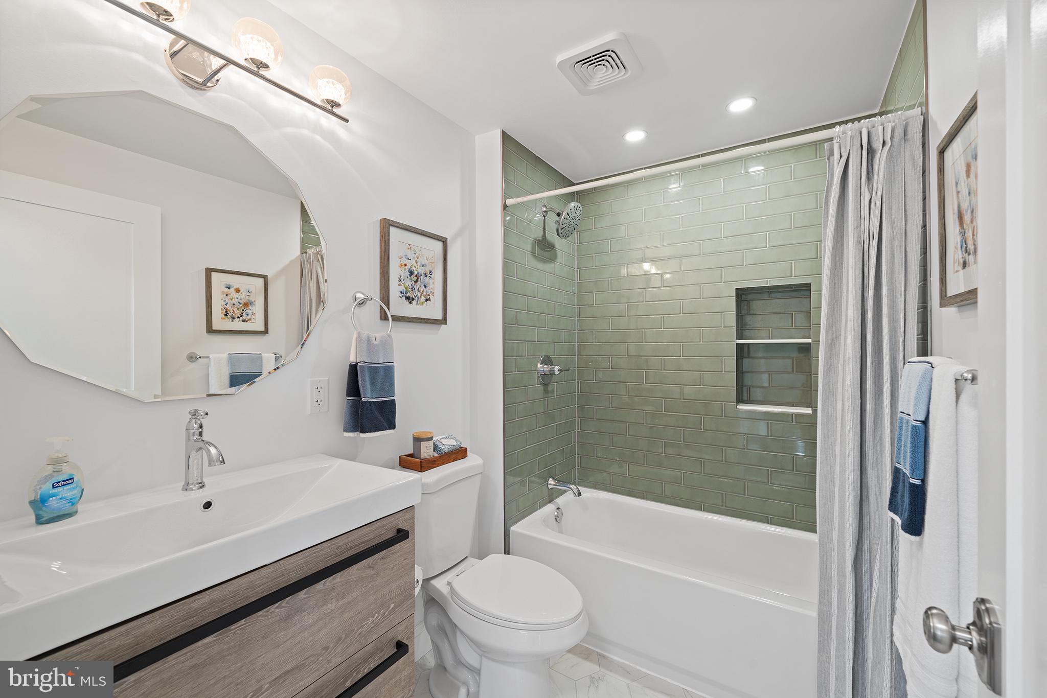 1708 Gallagher Road Plymouth Meeting, PA 19462 - Photo 22 of 37 a bathroom with a bathtub shower sink mirror vanity and toilet