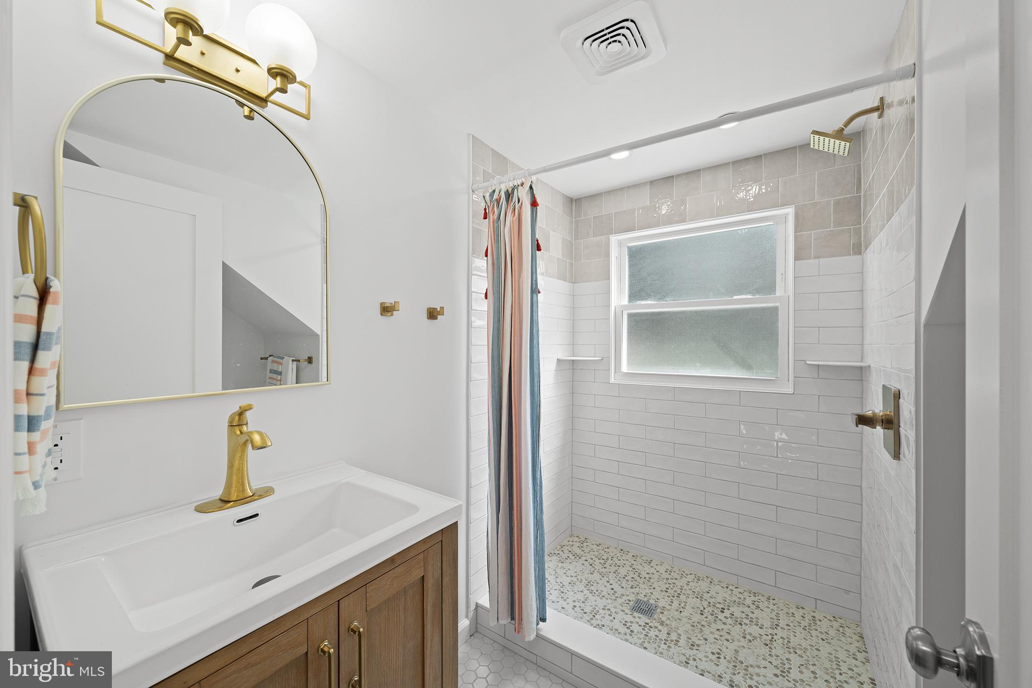 1708 Gallagher Road Plymouth Meeting, PA 19462 - Photo 25 of 37 a bathroom with a sink vanity and shower