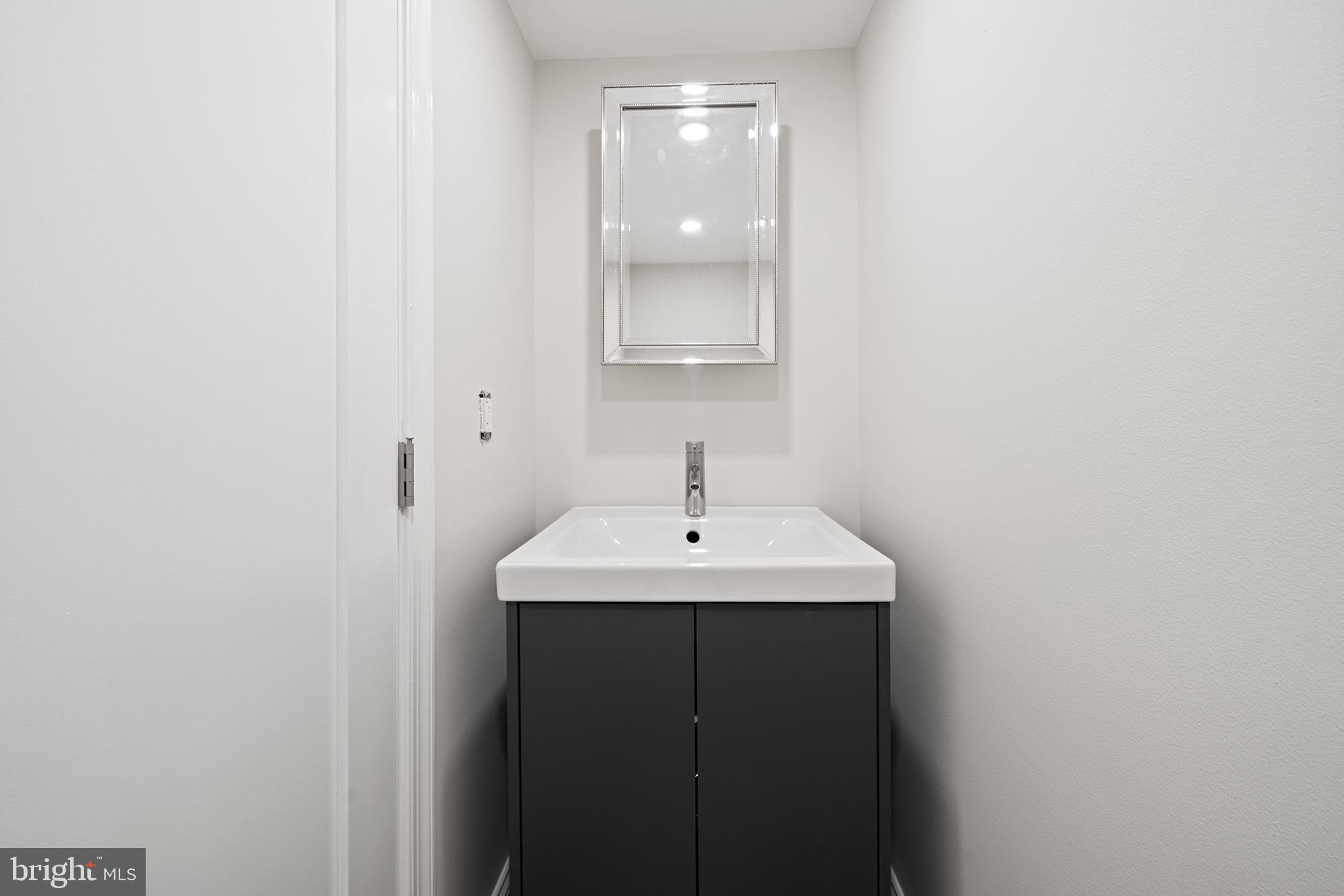 1708 Gallagher Road Plymouth Meeting, PA 19462 - Photo 30 of 37 a bathroom with a sink and a mirror