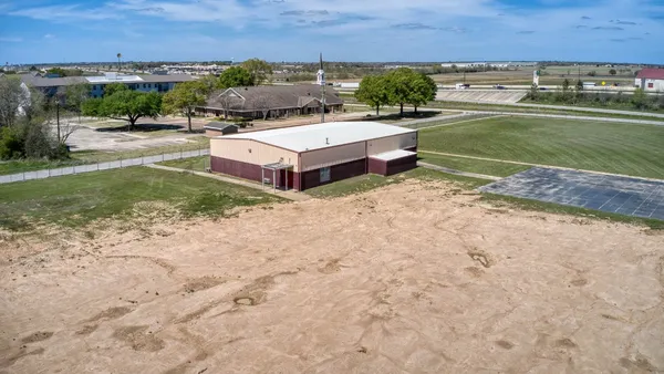 an aerial view of a house with a yard and lake view