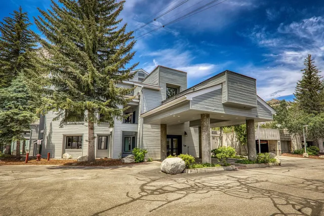 a front view of a house with garden and porch