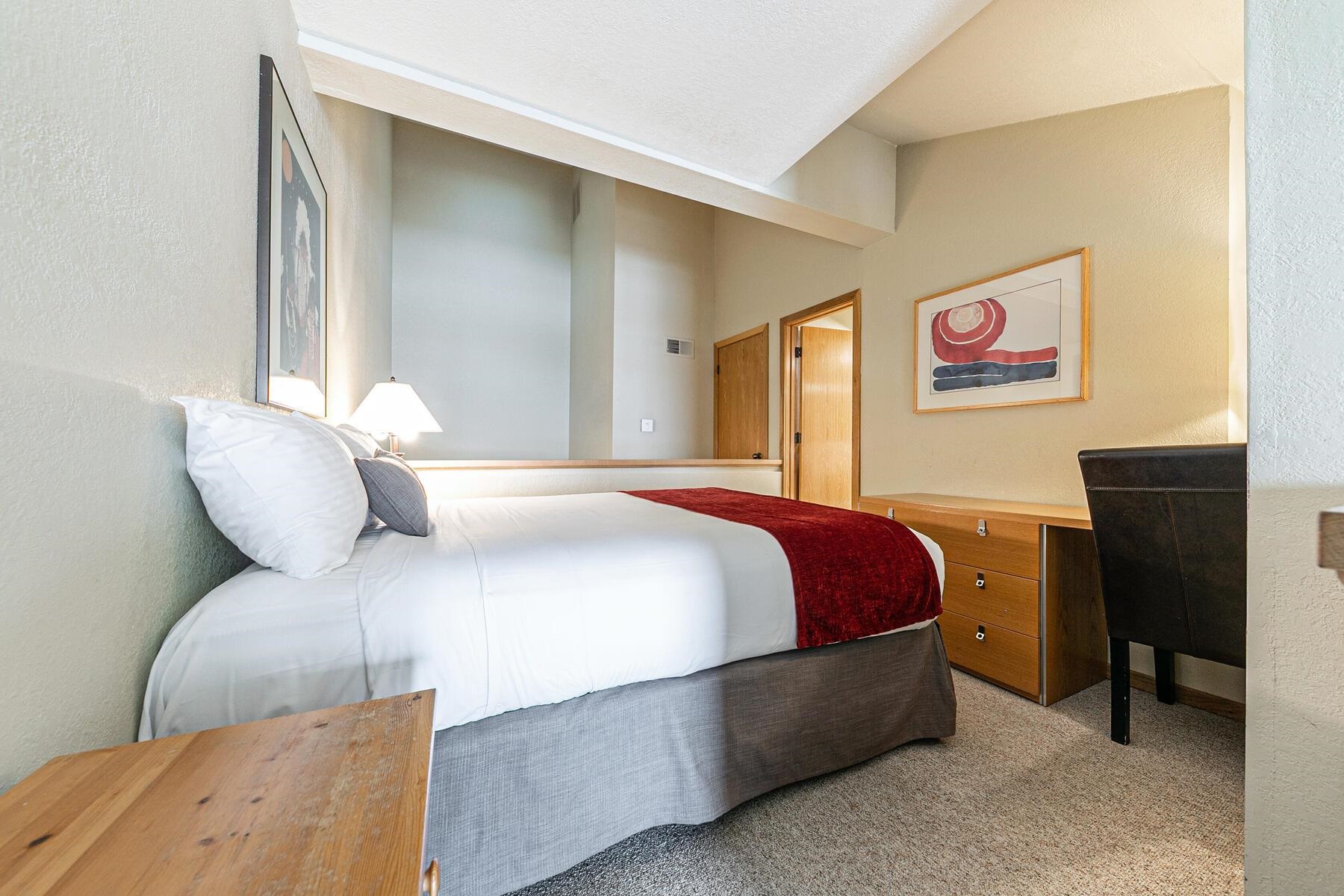 201 Shirley Cyn Road, Unit 311 Olympic Valley, CA 96146 - Photo 13 of 28 a bedroom with a bed and a chair