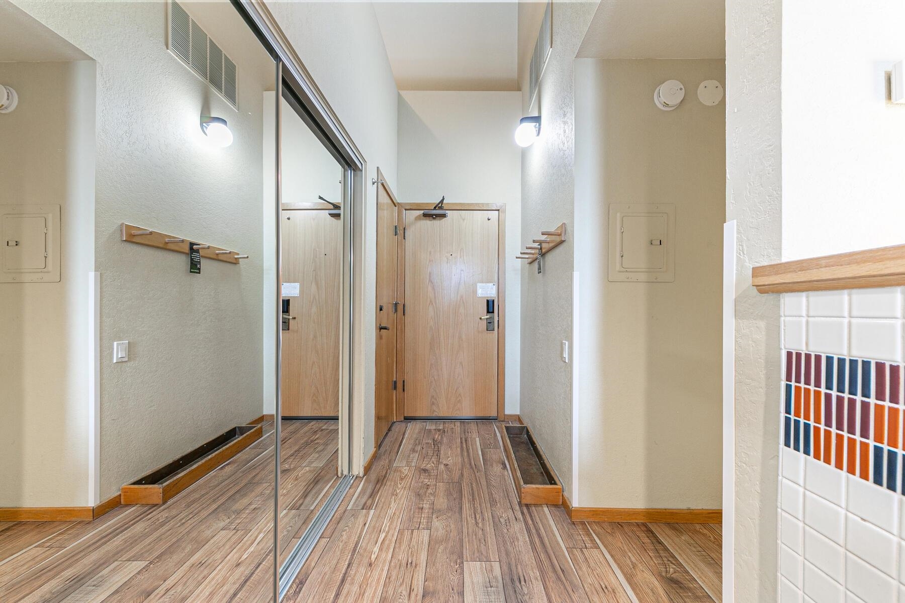 201 Shirley Cyn Road, Unit 311 Olympic Valley, CA 96146 - Photo 16 of 28 a view of a hallway with wooden floor and staircase