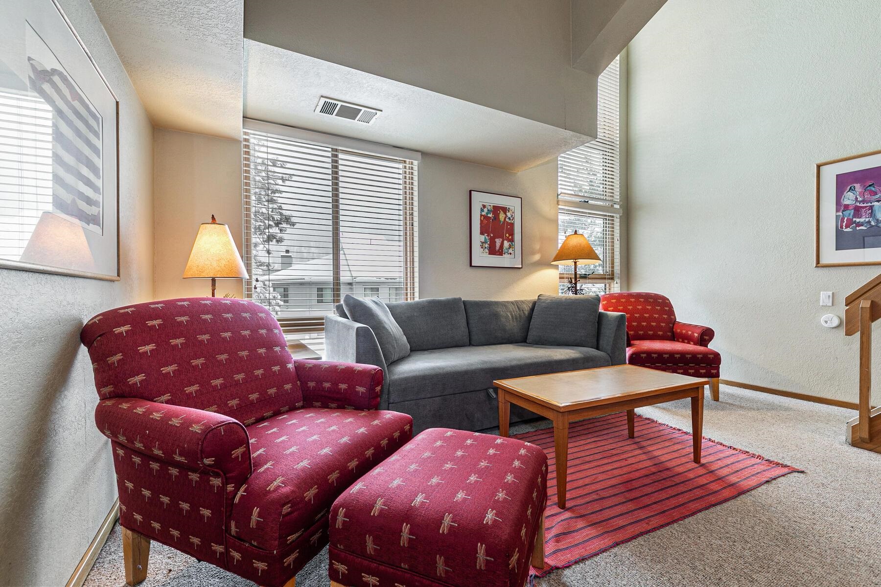 201 Shirley Cyn Road, Unit 311 Olympic Valley, CA 96146 - Photo 5 of 28 a living room with furniture a wooden floor and a large window