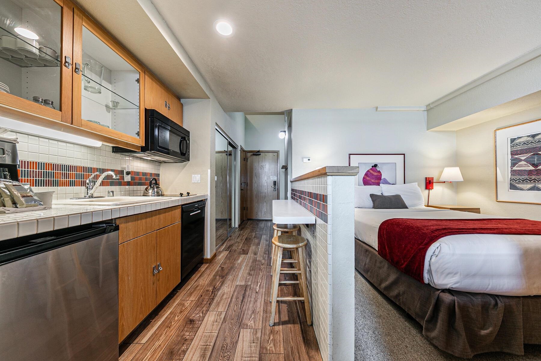 201 Shirley Cyn Road, Unit 311 Olympic Valley, CA 96146 - Photo 9 of 28 a kitchen with stainless steel appliances granite countertop a sink and dishwasher a stove top oven with wooden floor
