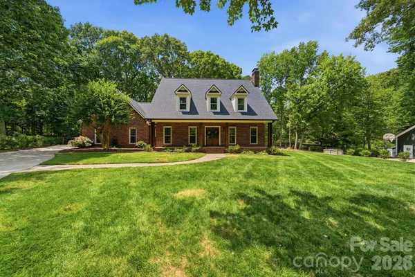 a front view of house with yard and green space
