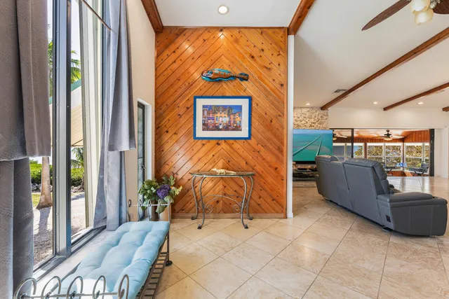 a dining room with furniture and a large window