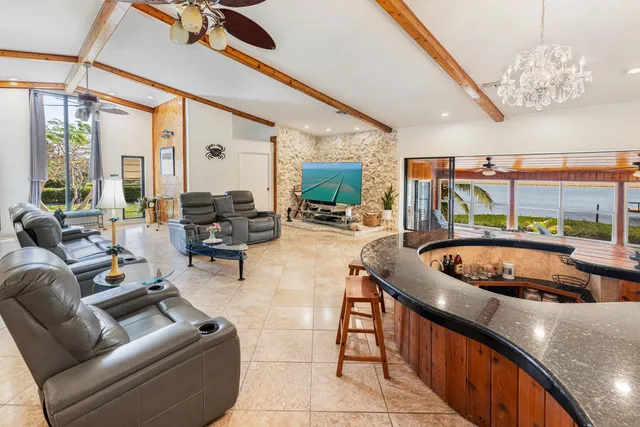 a kitchen with stainless steel appliances granite countertop a stove a refrigerator a sink dishwasher and white cabinets with wooden floor