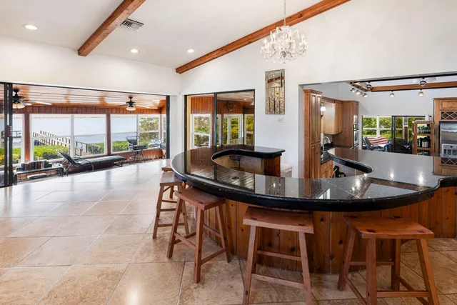a dining room with furniture a chandelier and a rug