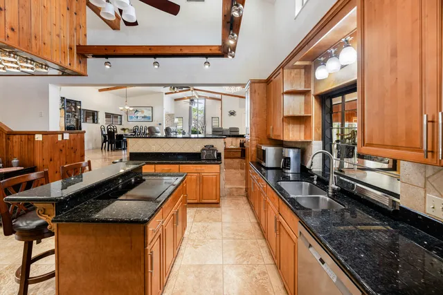 a bedroom with a bed and dresser with wooden floor