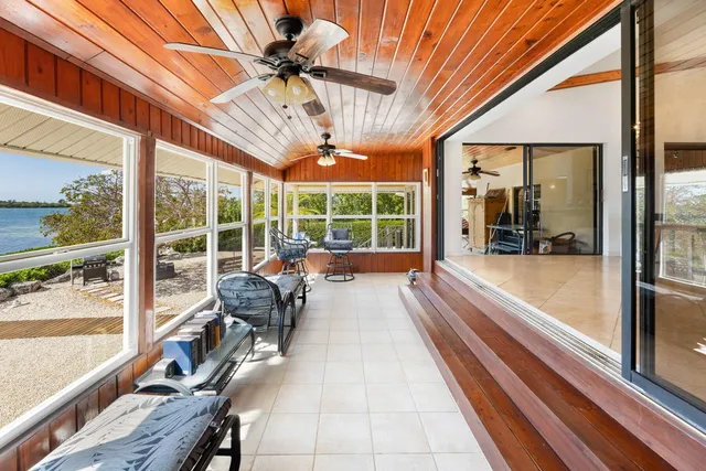 a bedroom with a bed a window and a chandelier