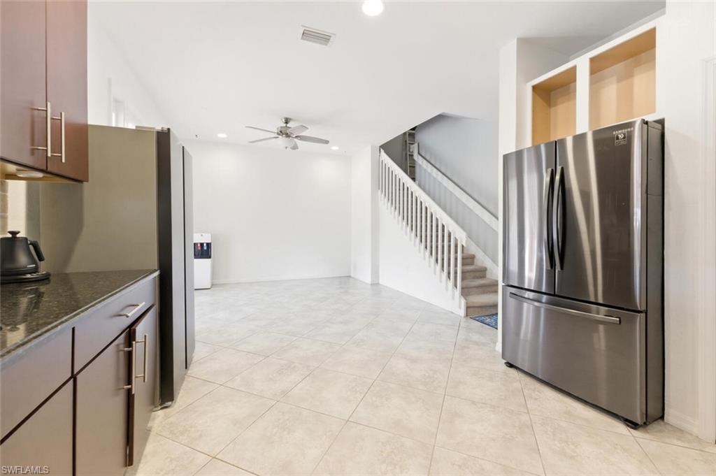 7577 Bristol Circle Naples, FL 34120 - Photo 13 of 41 a kitchen with stainless steel appliances granite countertop a refrigerator and a sink