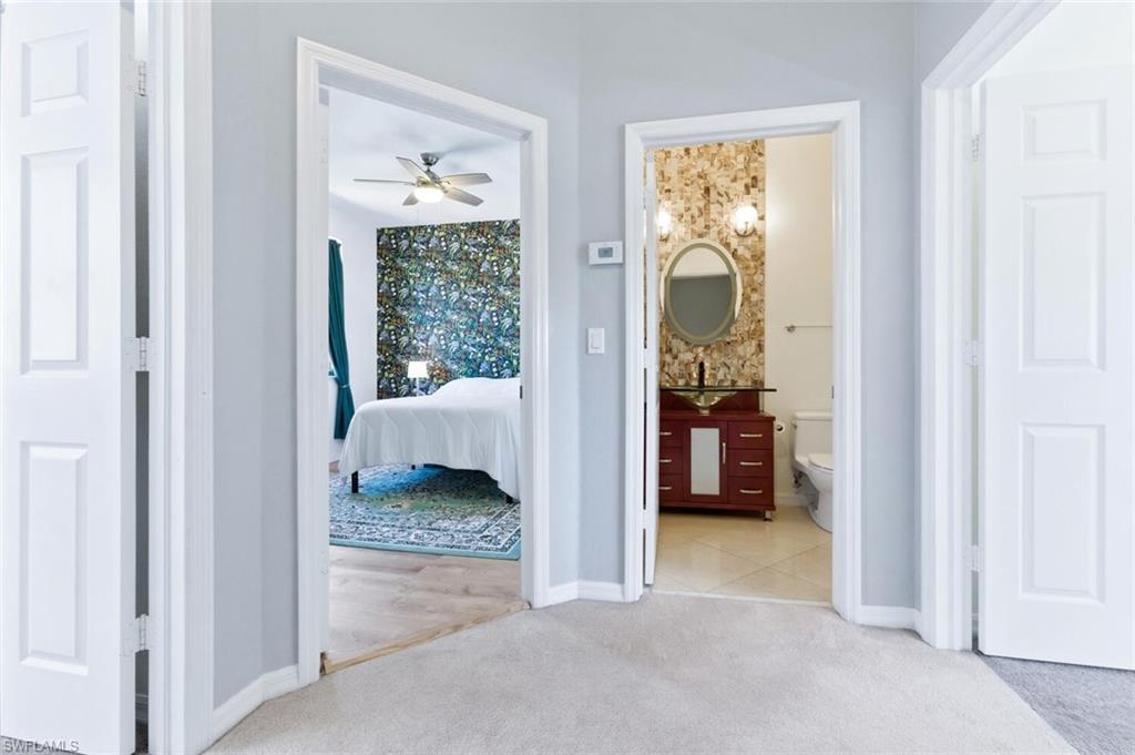 7577 Bristol Circle Naples, FL 34120 - Photo 17 of 41 a bedroom with a bed and a view of bedroom