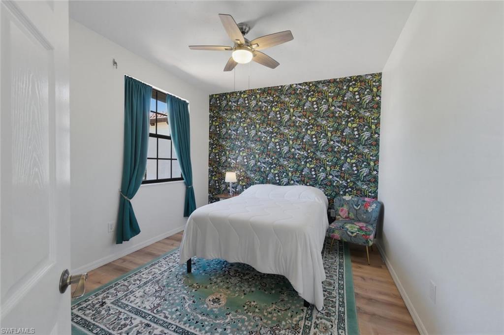 7577 Bristol Circle Naples, FL 34120 - Photo 19 of 41 a bedroom with a bed and a window