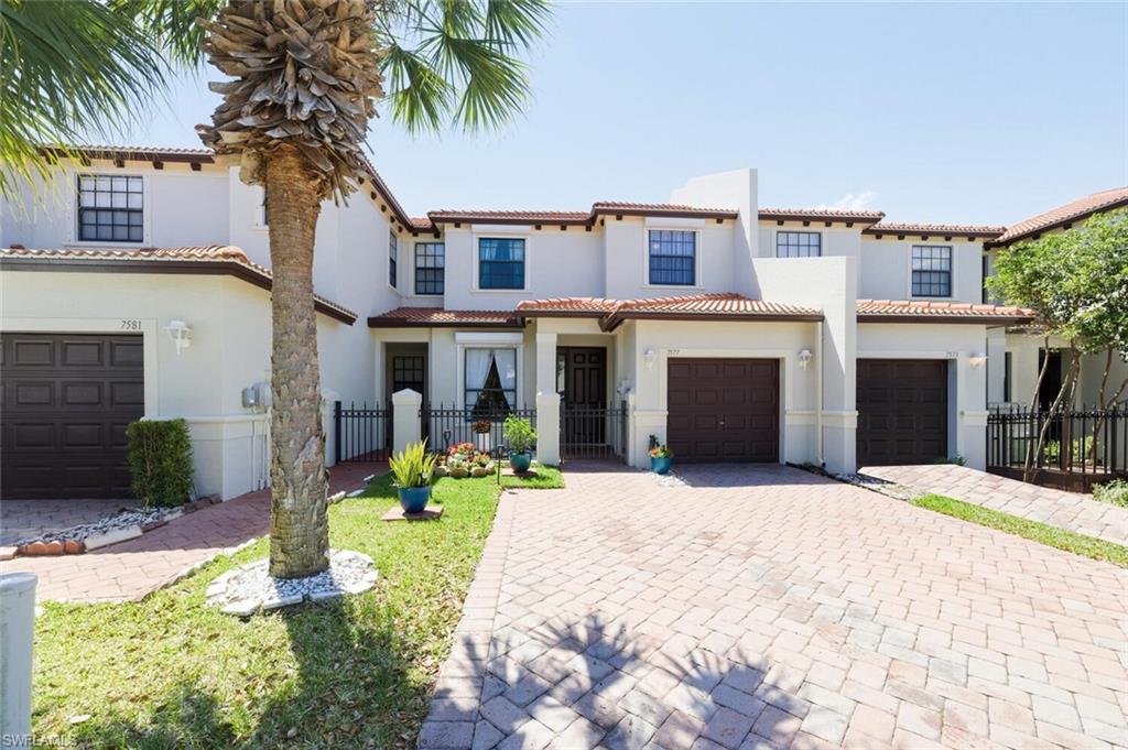 7577 Bristol Circle Naples, FL 34120 - Photo 2 of 41 a front view of a house with a yard and potted plants
