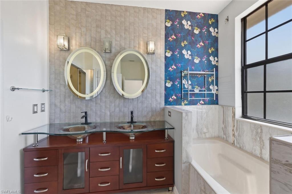 7577 Bristol Circle Naples, FL 34120 - Photo 21 of 41 a bathroom with a bathtub sink and mirror