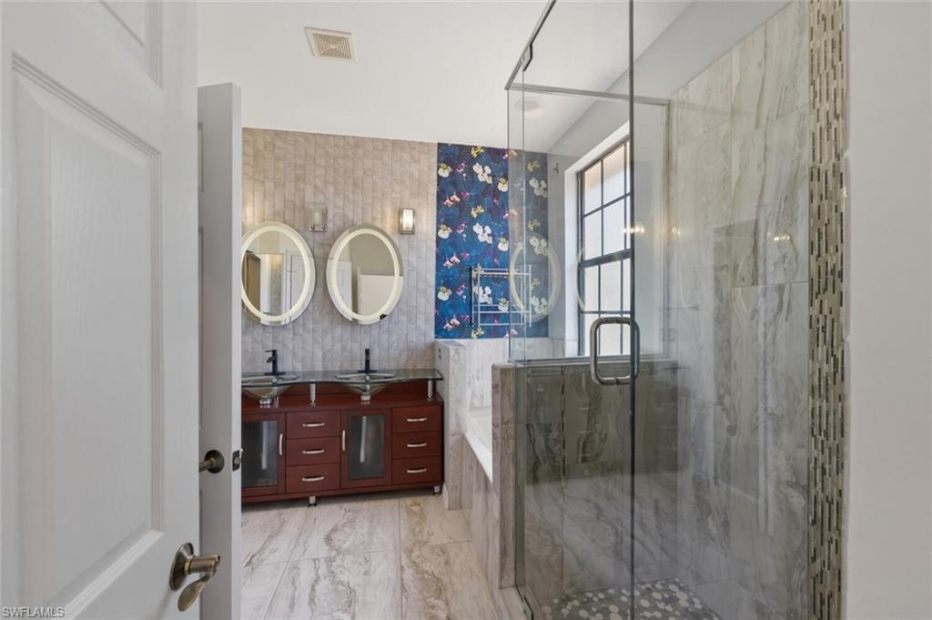 7577 Bristol Circle Naples, FL 34120 - Photo 22 of 41 a living room with a mirror and a table