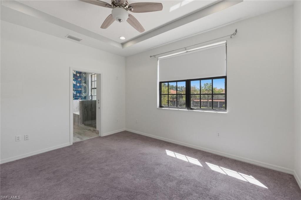 7577 Bristol Circle Naples, FL 34120 - Photo 23 of 41 an empty room with windows and fan
