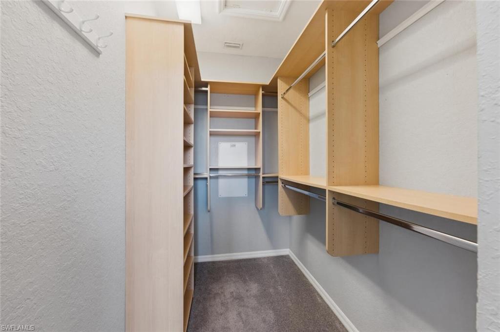 7577 Bristol Circle Naples, FL 34120 - Photo 25 of 41 a view of walk in closet with empty racks