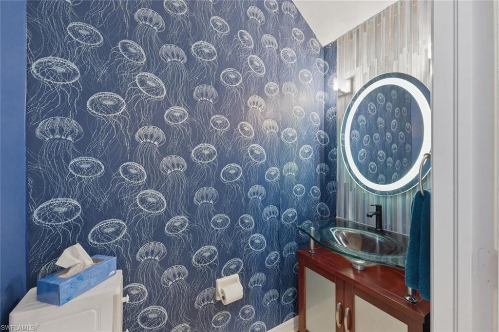 7577 Bristol Circle Naples, FL 34120 - Photo 31 of 41 a bathroom with a sink and a mirror