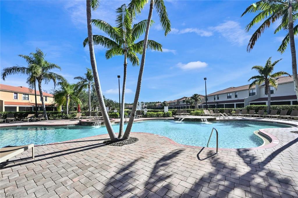 7577 Bristol Circle Naples, FL 34120 - Photo 37 of 41 a view of a swimming pool with a table and chairs