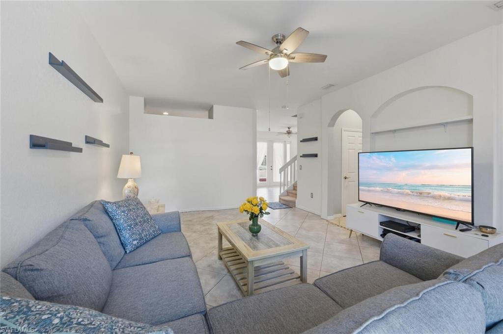 7577 Bristol Circle Naples, FL 34120 - Photo 7 of 41 a living room with furniture and a flat screen tv