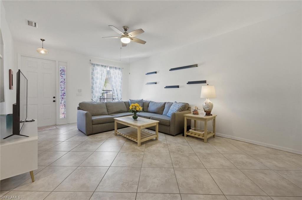 7577 Bristol Circle Naples, FL 34120 - Photo 8 of 41 a living room with furniture and a flat screen tv