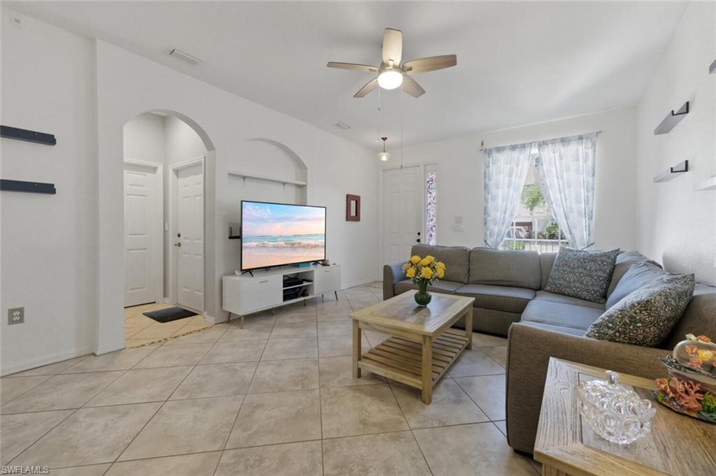 7577 Bristol Circle Naples, FL 34120 - Photo 9 of 41 a living room with furniture and a ceiling fan