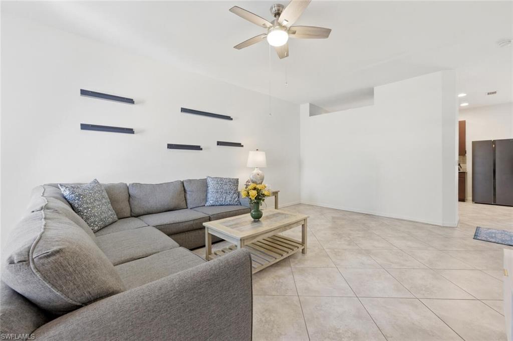 7577 Bristol Circle Naples, FL 34120 - Photo 10 of 41 a living room with furniture and kitchen view
