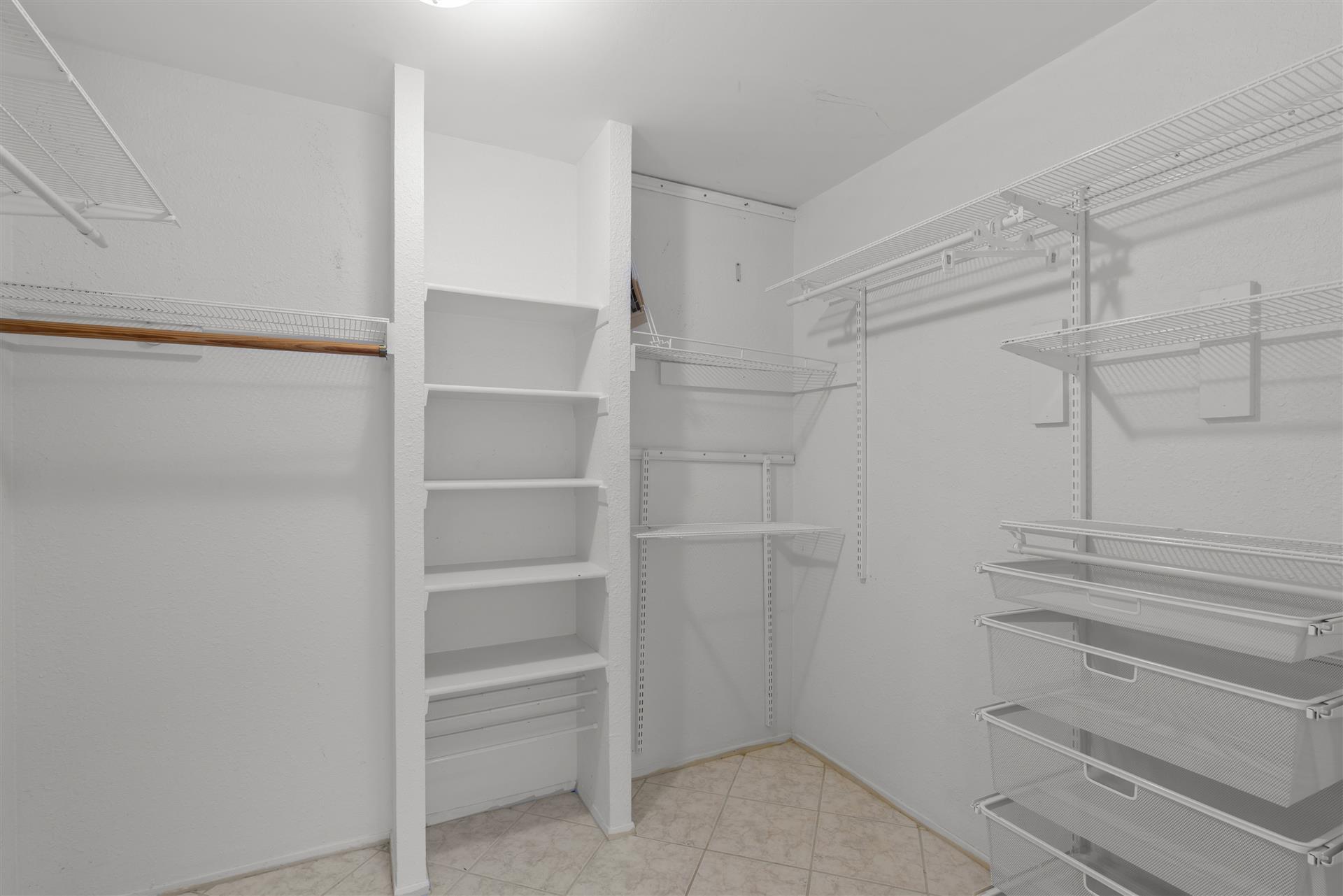 1710 Persimmon Road Cedar Park, TX 78613 - Photo 22 of 33 Customizable storage solutions define this practical and organized primary bedroom walk-in closet space.
