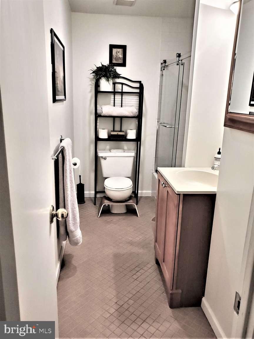 8 Rex Avenue, Unit 11 Philadelphia, PA 19118 - Photo 11 of 25 a view of a hallway with workspace and mirror