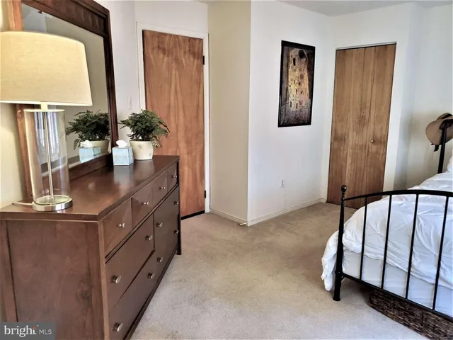 a view of a workspace with furniture and a book shelf