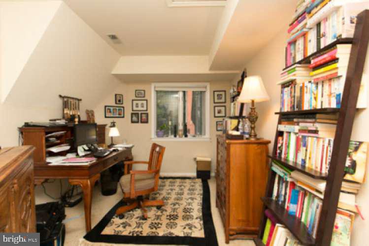 8 Rex Avenue, Unit 11 Philadelphia, PA 19118 - Photo 14 of 25 a view of a workspace with furniture and a book shelf